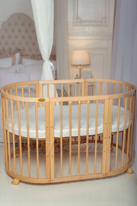 КРОВАТКА- ТРАНСФОРМЕР "COMFORT BABY" .Цена: 25 000 руб.  ХАРАКТЕРИСТИКИ:  возраст детей: 0-5 лет  габариты модели (Д х Ш х В): 1) колыбельки: 78*76*81 см  2) овальной кроватки: 128*76*81 cм  матрас приобретается отдельно.  максимальная нагрузка: 120 кг  Материал: изготавливается только из настоящего массива бука высшего сорта.  сборка: кровать в разобранном виде, простота сборки, инструкция по сборке на русском языке  продукция сертифицирована  производство: Россия  гарантия: 2 года   Дополнительные характеристики: 4 положения по высоте (расстояние положения дна от пола без колес: 1см, 12см, 37см, 57см; расстояние между отверстиями снизу-наверх: 12см, 15см, 20см.); 3 прутика - съемные.  КОНМПЛЕКТАЦИЯ:  1-я ступень - круглая кроватка  2-я ступень - овальная кроватка  3-я ступень - диванчик  4-я ступень - манеж  5-я и 6-я ступени - 2 кресла и столик  7-я ступень - пеленальный столик  ДОПОЛНИТЕЛЬНЫЕ ОПЦИИ:  Комплект постельный "Classic" +6950 руб.  Комплект постельный "Colorit" + 11990 руб.  Фирменный держатель для балдахина +790 руб.  Комплект цельных матрасов " Холкон"/ "Кокос" (круглый+овальный) +8490 руб  Маятник "ComfortBaby Pendulum" 2 в 1+6990 руб.